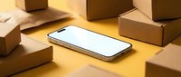 Smartphone with blank white screen surrounded by cardboard delivery boxes on yellow background, online shopping and e-commerce concept.