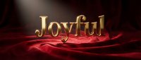 Joyful golden text on luxurious red velvet fabric with dramatic spotlight, elegant typography for holiday greeting cards and festive designs.