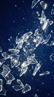 Shattered glass fragments exploding with prismatic light effects against deep blue starry background for dynamic design projects.