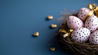 Pink polka dot Easter eggs with gold accents nestled in natural nest against dark blue background, with scattered heart decorations creating festive holiday mood.