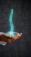 Holographic spine floating above cupped hands showing medical technology concept for healthcare innovation and spinal treatment solutions.