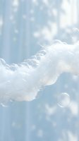 Dreamy white fluffy clouds floating in soft blue sky with ethereal light rays and bokeh effects creating peaceful heavenly atmosphere for meditation content.