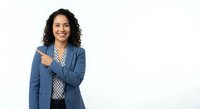 Professional Hispanic businesswoman in blue blazer pointing and smiling confidently on white background for corporate presentations and marketing materials.