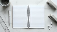 Open spiral notebook with blank lined pages surrounded by white office supplies including pen, ruler, stapler, tape dispenser and paper clips on clean desk.