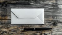 White envelope and black pen on rustic wooden table background, business correspondence concept for office, mail, and communication purposes.