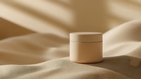 Minimalist cream cosmetic jar on beige silky fabric with soft shadows, luxury skincare product photography for beauty and wellness marketing.
