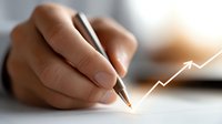 Professional hand drawing upward trending arrow graph with pen on paper representing business growth, financial success and positive market performance.