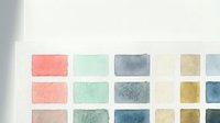Watercolor paint palette with colorful squares in pastel and earthy tones for artistic projects and creative design work.