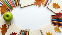 Autumn school supplies frame with colorful pencils, notebooks and fall leaves on white background. Back to school concept for educational projects.