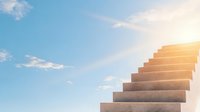Concrete stairs ascending towards bright sunlit sky with white clouds, symbolizing growth, success, and spiritual journey. Minimalist architectural composition.