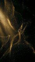 Golden glitter particles flow and swirl against dark background, creating elegant light trails and sparkling effects for luxury, celebration, and premium design projects.