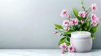 White cosmetic cream jar with fresh pink carnation flowers on light background, natural skincare concept for beauty and wellness products.