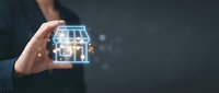 Smart home technology concept, hand holding glowing digital house with connected IoT devices and automation system for residential property management and control.