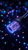 Glowing LED stage light with red and blue sparkles against dark background with colorful bokeh effects, creating magical atmosphere for entertainment design.