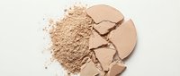 Broken beige powder compact with crushed makeup scattered on white surface, suitable for beauty, cosmetics, and skincare product advertising.