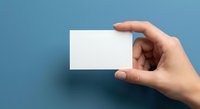 Hand holding blank white business card mockup on blue background for branding and corporate identity design projects.