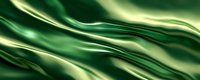 Abstract emerald green silk fabric with smooth flowing waves and golden highlights creating luxurious texture for fashion, interior design, or elegant backgrounds.