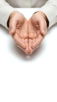 Open cupped hands in protective gesture on white background showing care, support and offering help in business or healthcare concept.