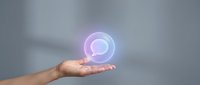 Young adult hand holding glowing neon orb with purple and blue light, representing technology, innovation, energy, and digital future concepts for web design and marketing.