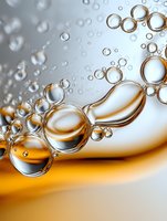 Macro shot of transparent bubbles floating in liquid with golden amber background, showing surface tension and light refraction in spherical droplets.