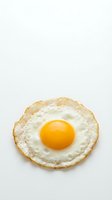 Fried egg with golden yolk isolated on white background for breakfast menu design and culinary projects.