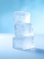 Stacked transparent ice cubes on light blue background with soft shadows, showing crystalline structure and melting edges. Clean minimal composition for beverage and cooling concepts.