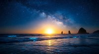 Stunning night sky with Milky Way galaxy over ocean waves at sunset. Dramatic seascape with rock formations and starry cosmos for astronomy and nature themes.