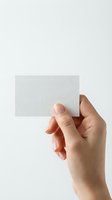 Hand holding blank white business card mockup against clean background for branding and corporate identity design projects.