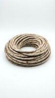 Coiled weathered garden hose made from natural fiber material, displaying aged texture and worn surface. Suitable for gardening, landscaping, and outdoor maintenance projects.