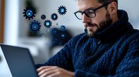 Professional in blue sweater working on laptop with digital technology icons floating above, representing innovation and digital transformation in modern workplace.