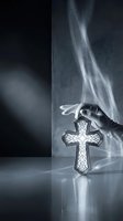 Caucasian hand holding ornate glowing cross pendant against dark textured wall with ethereal light rays, symbolizing faith, spirituality, and divine connection for religious and inspirational design use.