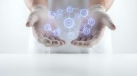 Hands protecting glowing digital network icons representing connectivity, technology innovation, cybersecurity and data protection in modern business.