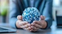 Hands holding glowing blue sphere made of connected dots representing global network connectivity and digital transformation in business environment.