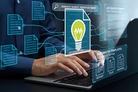 Business professional using laptop with digital innovation interface displaying lightbulb icon and connected data elements for creative technology solutions.