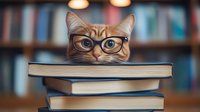 Ginger cat wearing glasses peeks over stack of books in library setting with soft bokeh lighting, creating whimsical academic atmosphere for education concepts.