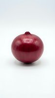Fresh red onion with papery skin and root end on white background, suitable for food photography, culinary content, and grocery retail applications.