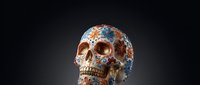Ornate decorative skull with intricate blue and orange floral patterns on dark background for Day of the Dead celebrations and cultural artwork designs.