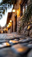 Warm evening ambiance with glowing lights along stone pathway framed by tropical palm fronds creating cozy outdoor dining atmosphere for hospitality design.
