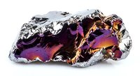 Iridescent metallic foil crumpled into abstract sculptural form with purple, gold and silver reflective surfaces on white background for modern design.