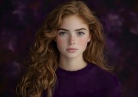 Young woman with long wavy auburn hair wearing purple knit sweater against dark floral background, natural makeup and freckles create ethereal portrait mood.