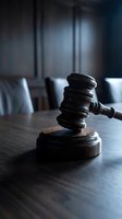 Wooden judge gavel on courtroom table with blurred background for legal proceedings and justice system concepts.