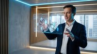 Professional businessman interacting with holographic interface technology in modern office environment for futuristic business presentations.