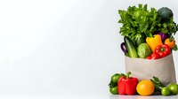 Fresh colorful vegetables and fruits in eco-friendly reusable shopping bag on white background, healthy eating and zero waste lifestyle concept.