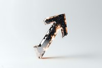 Diagonal black arrow with glowing orange edges and metallic texture stands against light background, creating dramatic contrast and dynamic movement effect.