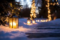 Cozy winter evening scene with glowing lantern in snow and warm bokeh lights creating magical holiday atmosphere for seasonal decorations and celebrations.