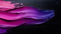Vibrant pink and purple paint strokes blend into deep blue creating dynamic flowing movement against dark background, artistic abstract macro photography.