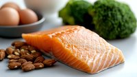 Fresh raw salmon fillet with broccoli, eggs and mixed nuts on white background. Healthy omega-3 rich ingredients for nutritious meal preparation.
