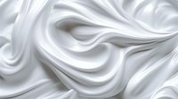 Luxurious white silk fabric with soft elegant folds and waves creating smooth flowing texture. Abstract background with gentle curves and graceful movement.
