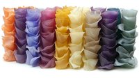 Colorful rows of delicate ruffled fabric arranged in vertical pleats creating an abstract textile pattern with orange, purple, blue, yellow, and mint tones.