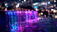 Cascading water illuminated by vibrant neon purple and blue lights creates magical nighttime atmosphere with glowing bokeh effect and reflective ripples in dark water.